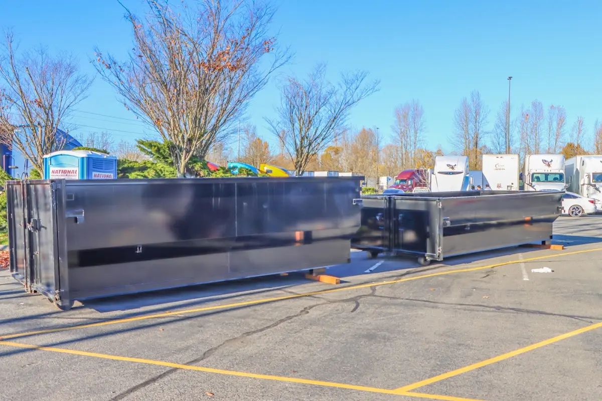 Professional dumpster rental service with roll-off container on residential driveway in Colonie